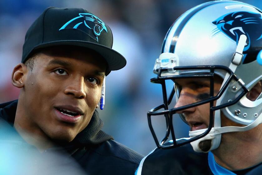 Injured Carolina Panthers quarterback Cam Newton, left, speaks with quarterback Derek Anderson during the Panthers' 19-17 win over the Tampa Bay Buccaneers on Sunday.