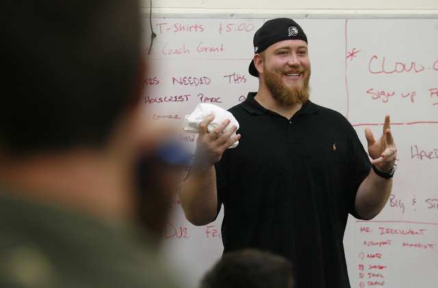 Sam Baker, a three-time All-American tackle at USC and a current starting left tackle for the Atlanta Falcons, talks to Costa Mesa High football players at school on Wednesday.
