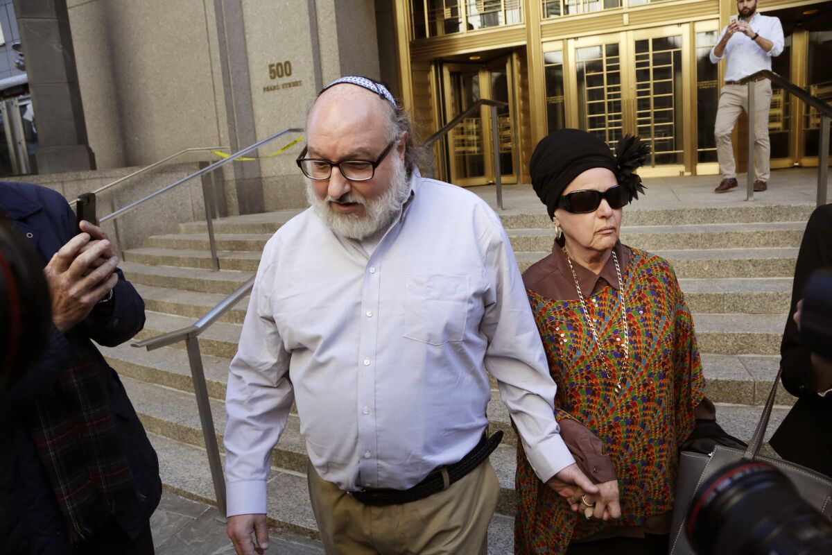 Forrmer U.S. intelligence analyst Jonathan Pollard, who spent three decades in prison for spying for Israel, leaves the federal courthouse in New York on Friday with his wife, Esther.