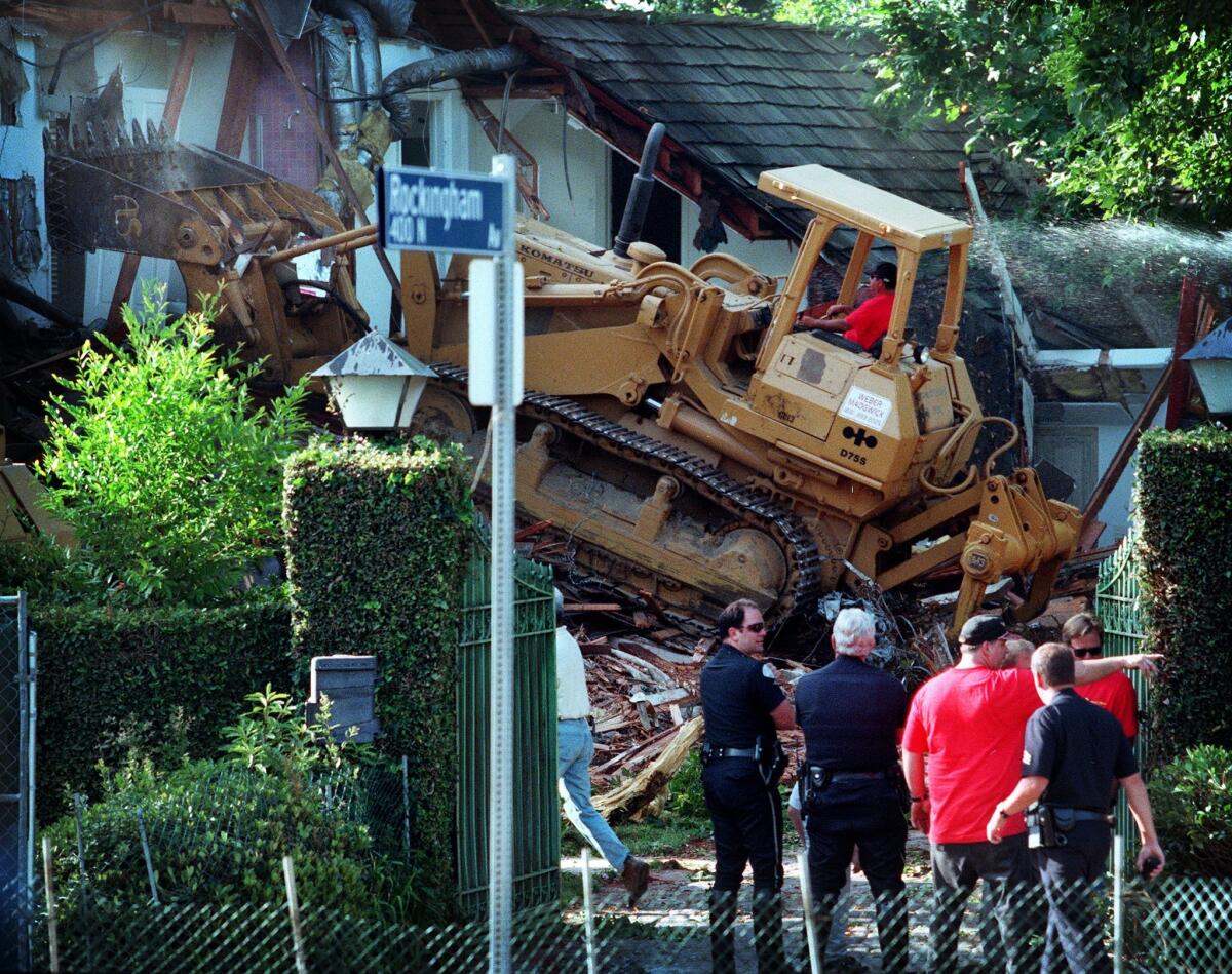 A bulldozer tears into the former home of O.J. Simpson in Brentwood in 1998.