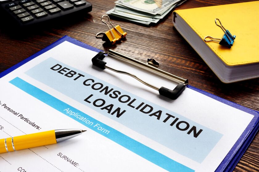 Debt consolidation loan form, notepad and calculator.