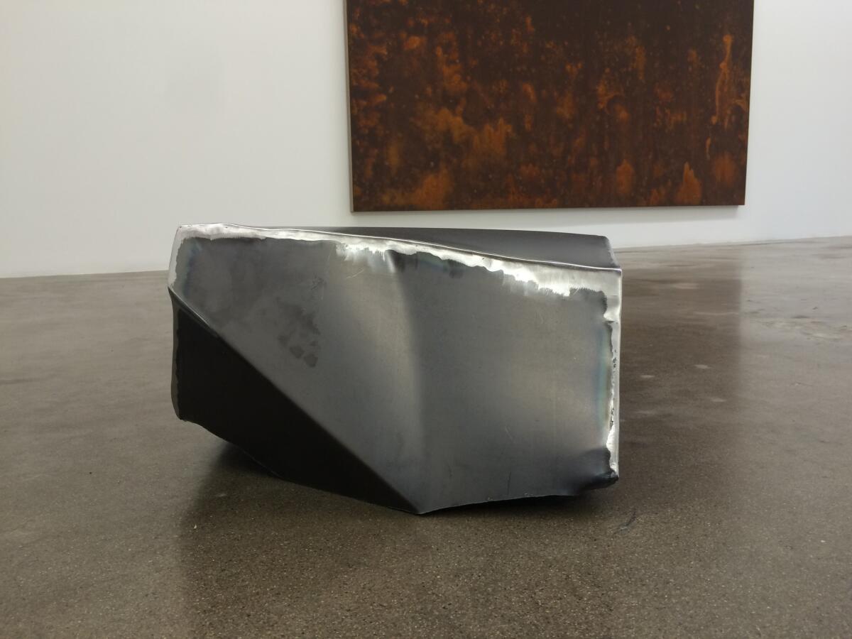 Ochoa's steel floor sculptures evoke chunks of broken concrete.