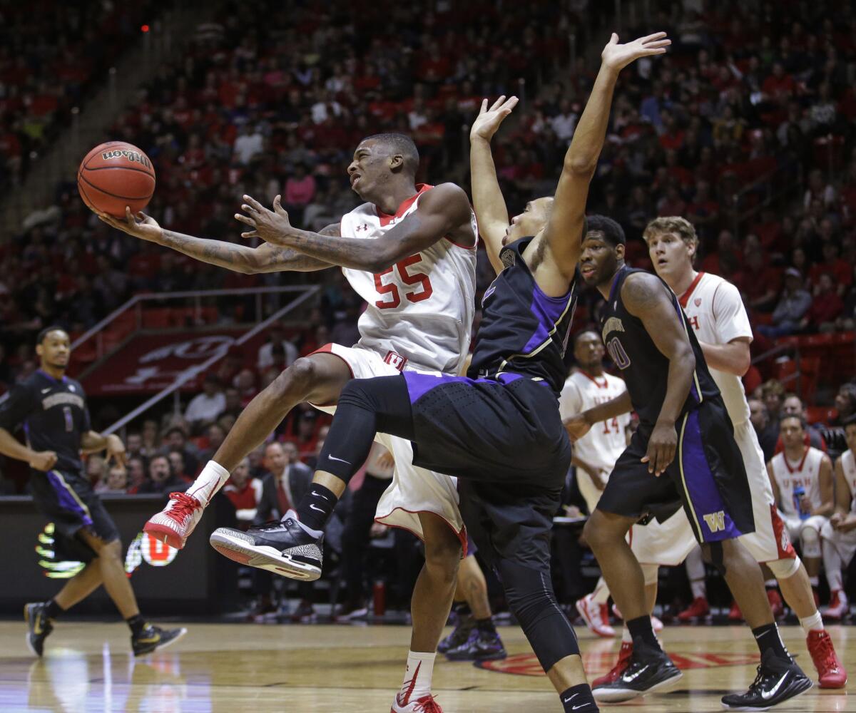 Utah guard Delon Wright flips the ball up as Washington guard Andrew Andrews tries to defend him.