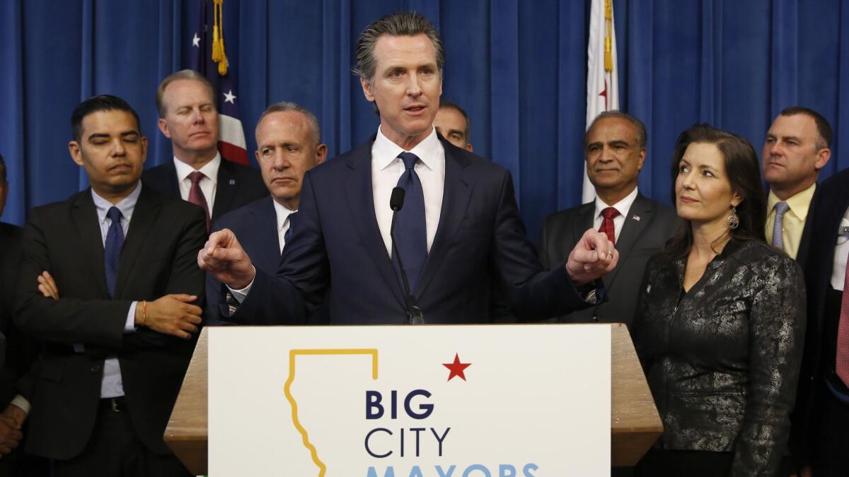 Gov. Gavin Newsom, center, discusses the homelessness problem facing California after a meeting in March with the mayors of some of the state's largest cities.