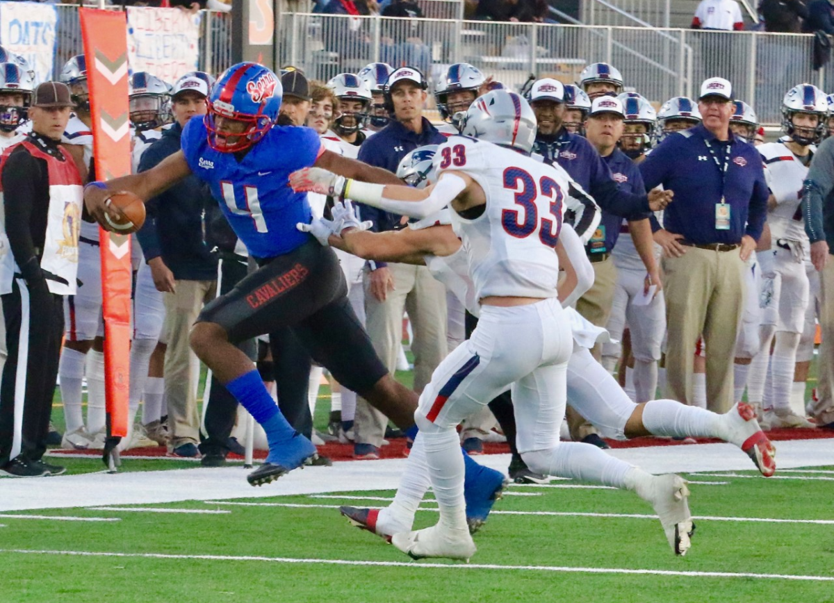 Gardena Serra quarterback Malik Murphy leaps over Bakersfield Liberty defender Kresean Kizzy.