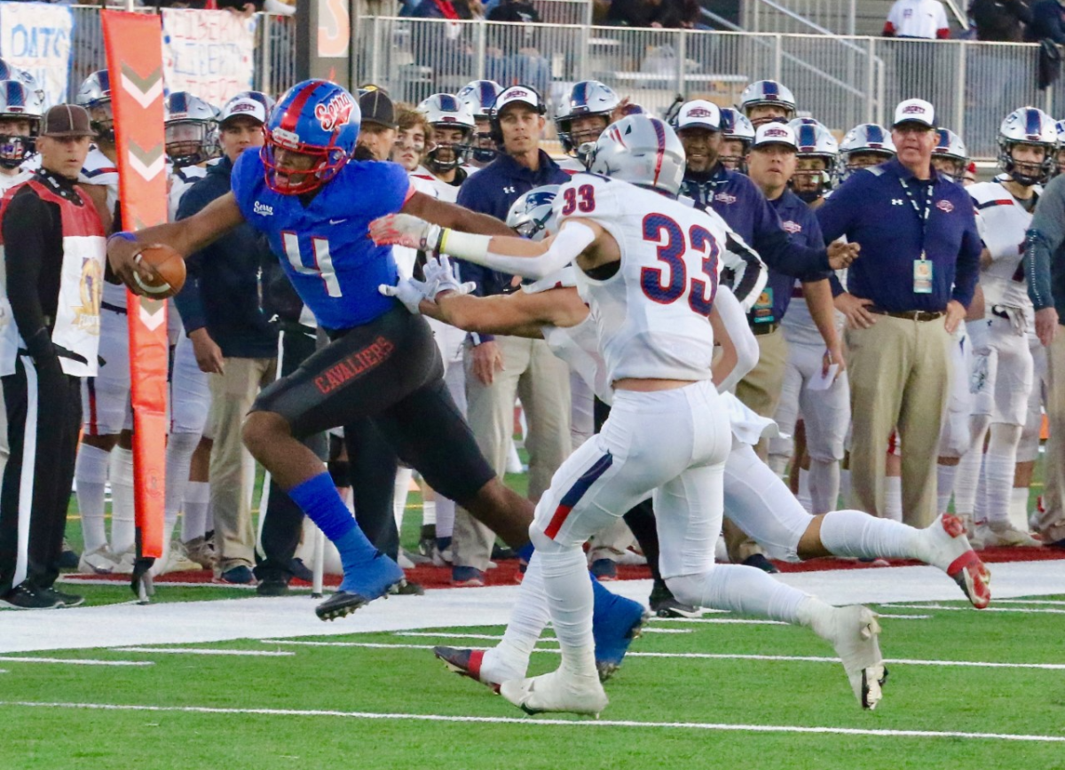 Gardena Serra quarterback Malik Murphy leaps over Bakersfield Liberty defender Kresean Kizzy.