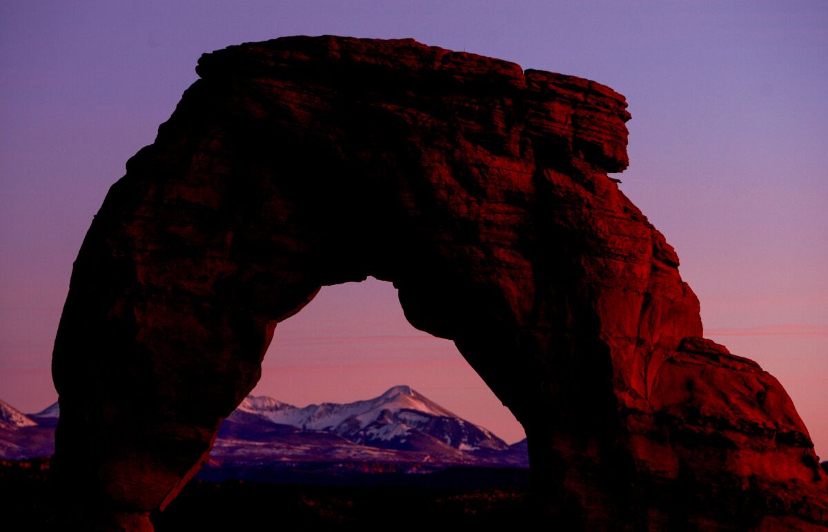 Delicate Arch in Arches National Park is seen at sunset.