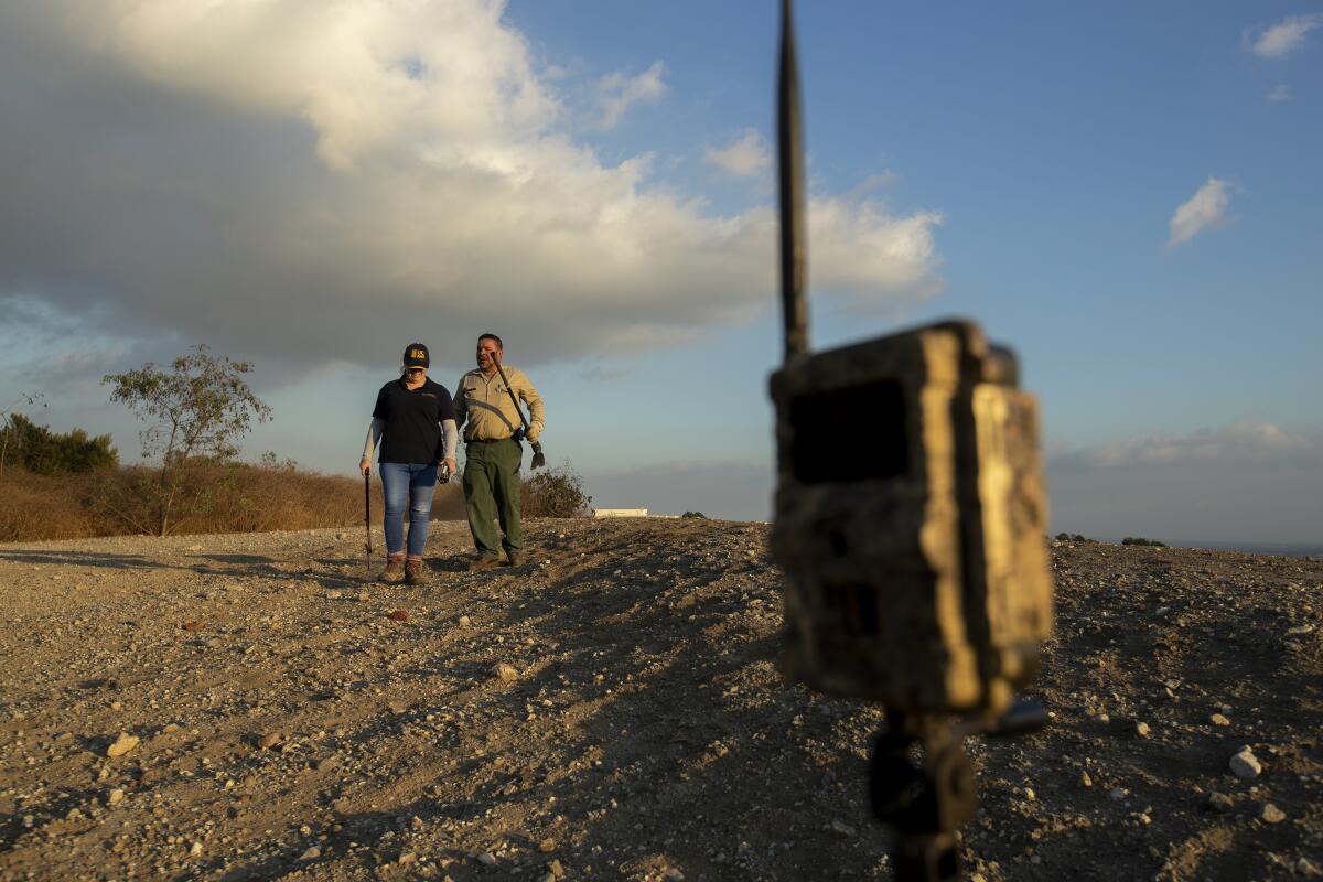 Fernando Barrera, Niamh Quinn hike to a research site in Monterey Park.