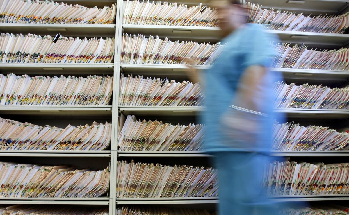 Bulky paper medical records like the ones in this 2006 photo were inconvenient, but they may have had this advantage over electronic patient files: security.