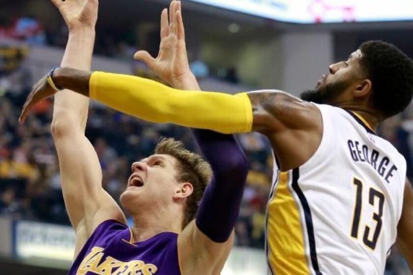 Pacers forward Paul George (13) blocks a shot attempt by Lakers center Timofey Mozgov during the first half on Nov. 1.