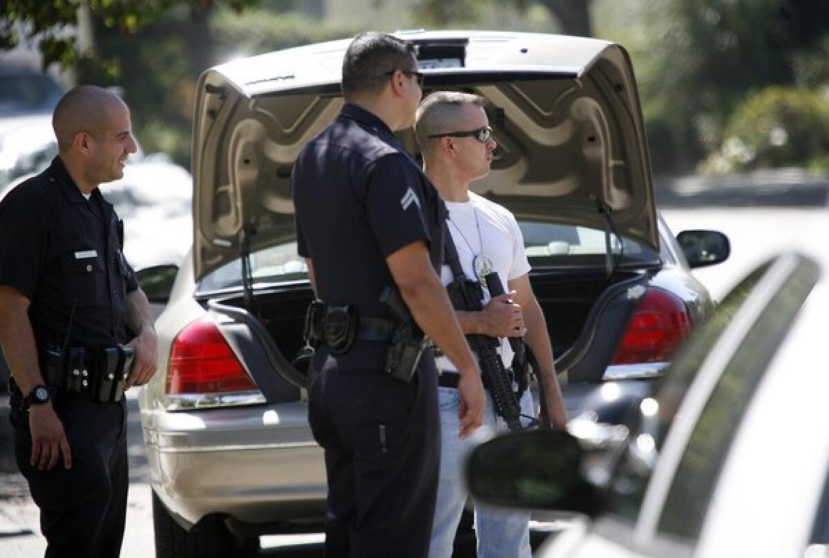 LAPD officers respond last year to what turned out to be a hoax call of a home-invasion robbery at a home owned by actor Ashton Kutcher.