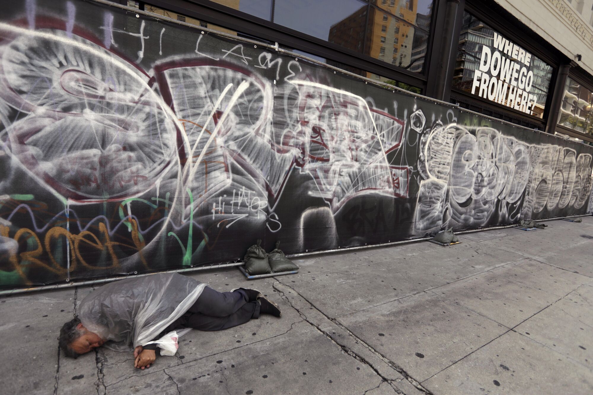 Juan Luna, who suffers from mental illness, sleeps along Los Angeles Street in downtown Los Angeles.