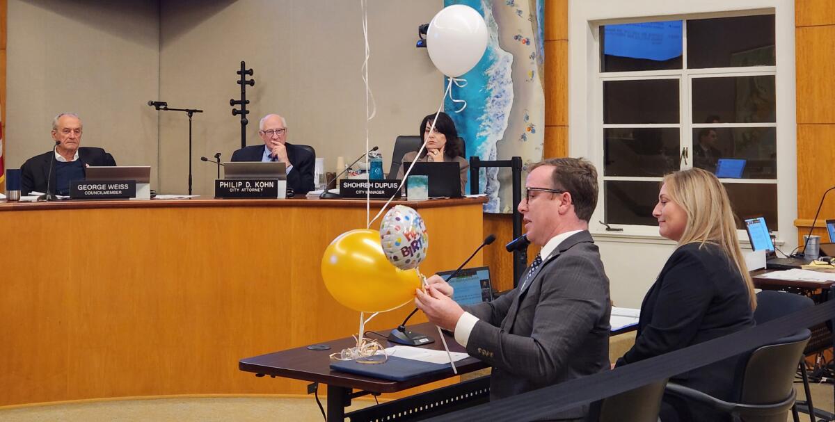 Jeremy Frimond, assistant to the city manager, demonstrates different types of balloons to the Laguna Beach City Council.