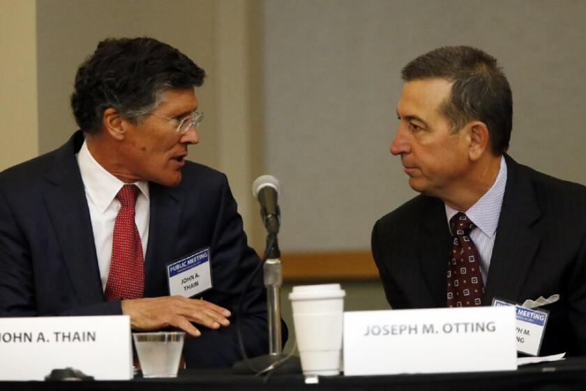 Bank regulators have approved CIT Group's takeover of OneWest Bank in Pasadena. Above, CIT Chief Executive John Thain and Onewest CEO Joseph Otting appeared at a Federal Reserve hearing on the merger in February.