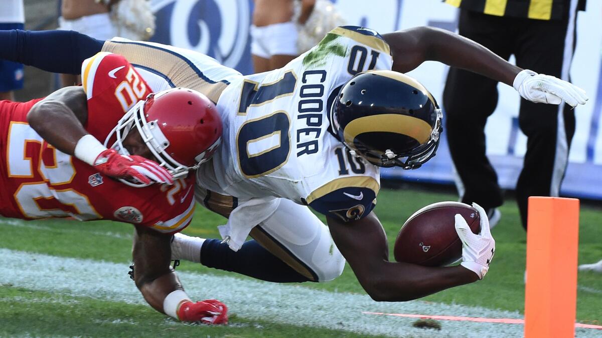 Rams receiver Pharoh Cooper dives over Kansas City's Steven Nelson for a touchdown on Aug. 20.
