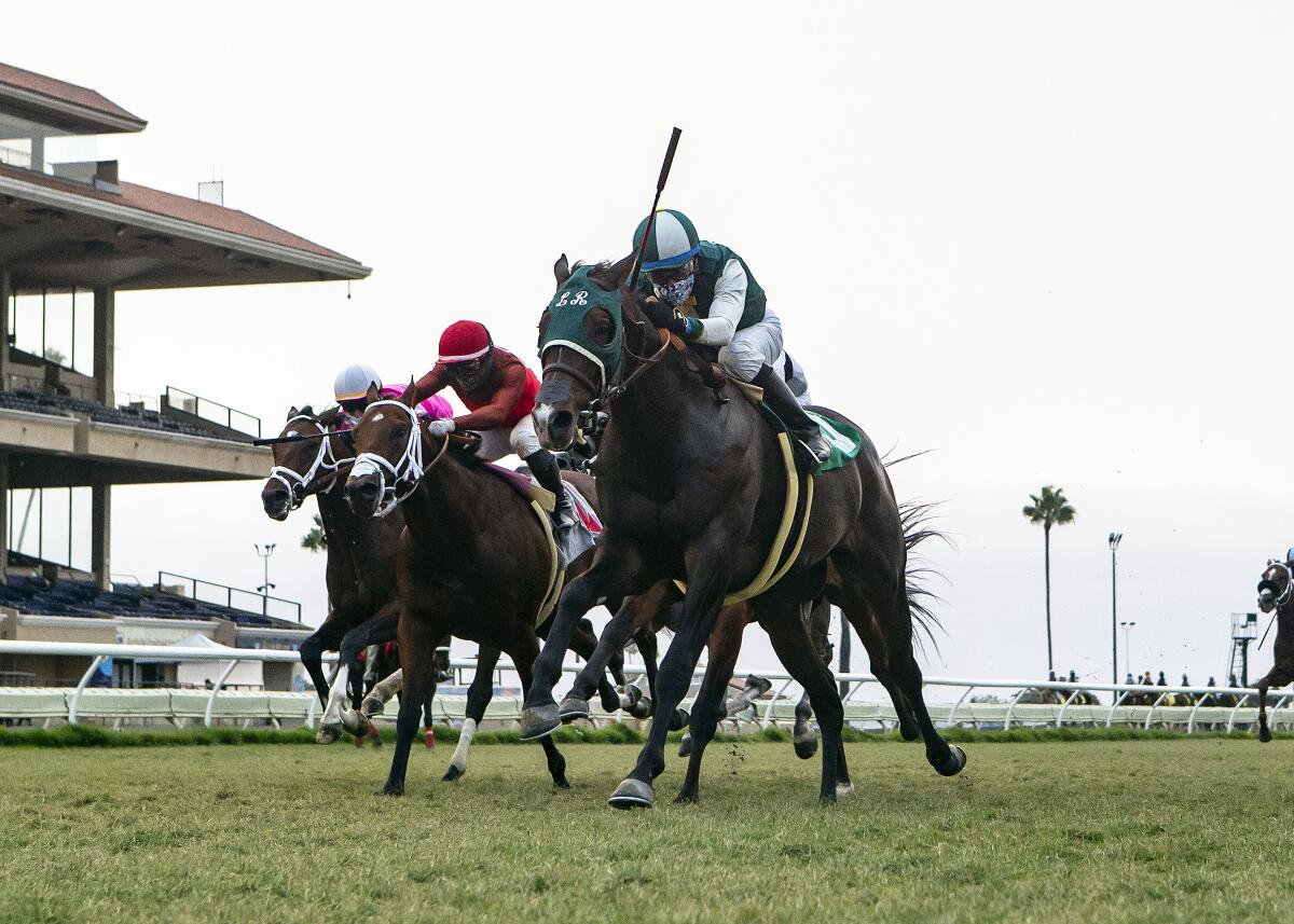 In this image provided by Benoit Photo, Big Fish, right,with Victor Espinoza aboard, wins the $100,000 Del Mar Juvenile Turf 