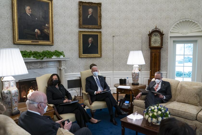President Joe Biden and Vice President Kamala Harris meet with Senate Majority Leader Sen. Chuck Schumer of N.Y., and other Democratic lawmakers to discuss a coronavirus relief package, in the Oval Office of the White House, Wednesday, Feb. 3, 2021, in Washington. (AP Photo/Evan Vucci)
