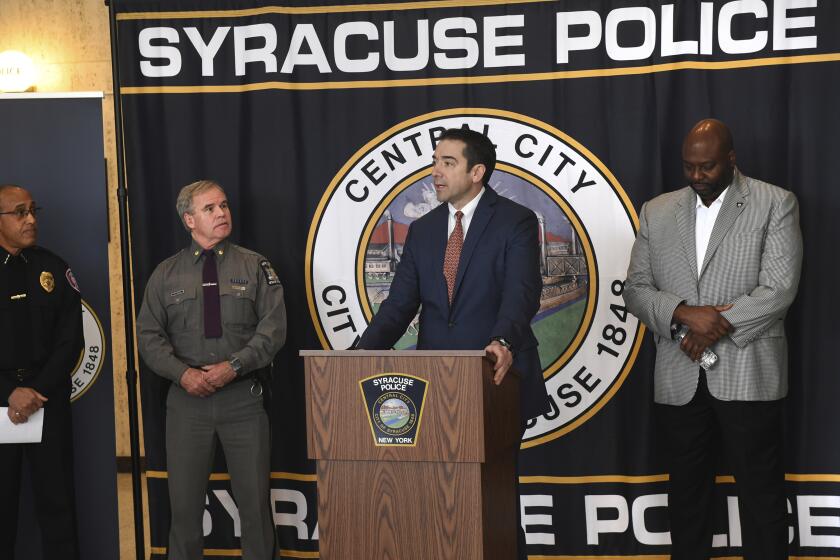 Peter Fitzgerald from the FBI addresses questions about a series of racist messages and hate crimes that have occurred at SU in the last two weeks during a press conference Tuesday, Nov. 19, 2019, at the Public Safety Building in Syracuse, N.Y. On the far left is Syracuse University DPS Chief Bobby Maldonado. Next to him is Major Philip Rougeux, Troop D Commander for the New York State Police. At right is Syracuse Police Chief Kenton Buckner. (Lauren Long/The Syracuse Newspapers via AP)