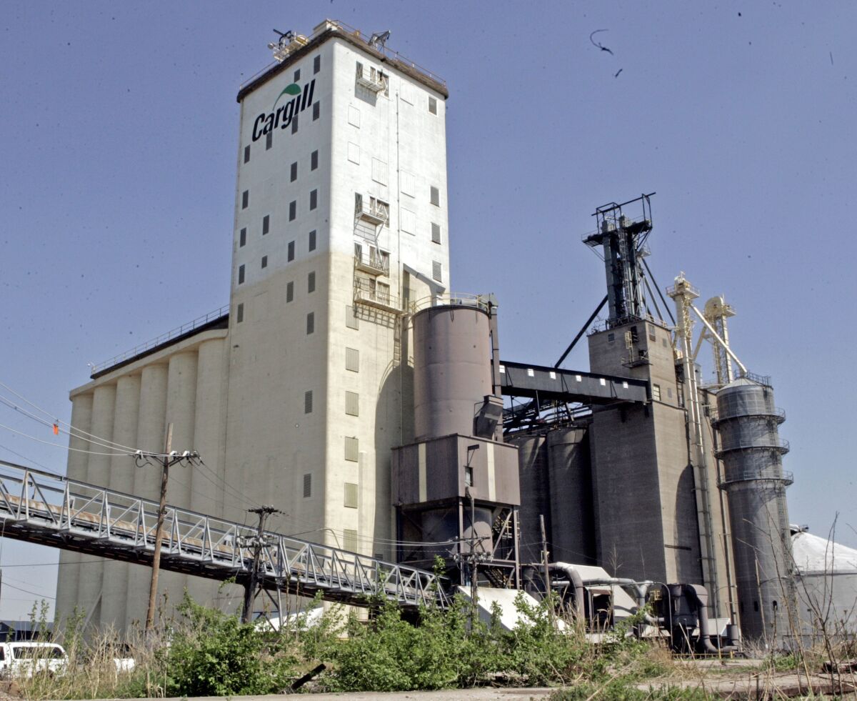 FILE - This April 12, 2006, file photo shows Cargill grain elevators in East St. Louis. Cargill and Continental Grain are teaming up in a joint venture to buy Sanderson Farms in a deal worth $4.53 billion as demand for chicken continues to rise. The companies will pay $203 per share in cash. Cargill and Continental Grain plan to combine Sanderson Farms with Wayne Farms, a Continental Grain subsidiary, to form a new, privately held poultry business. (AP Photo/James A. Finley, File)