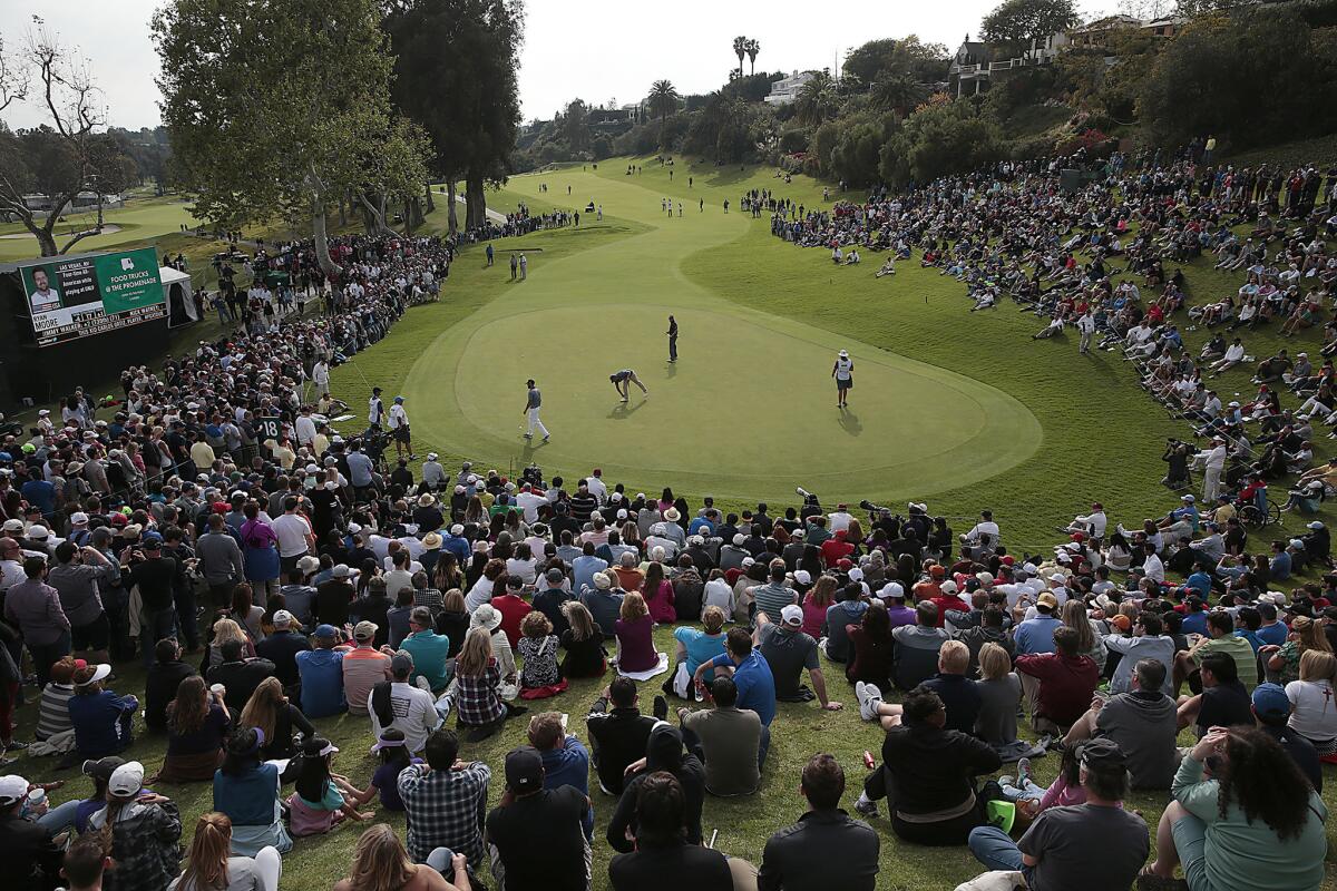 Spectators surround the 18th green as the last threesome of Retief Goosen, Graham DeLaet and Ryan Moore arrive during the third round three of the Northern Trust Open on Feb. 21, 2012.