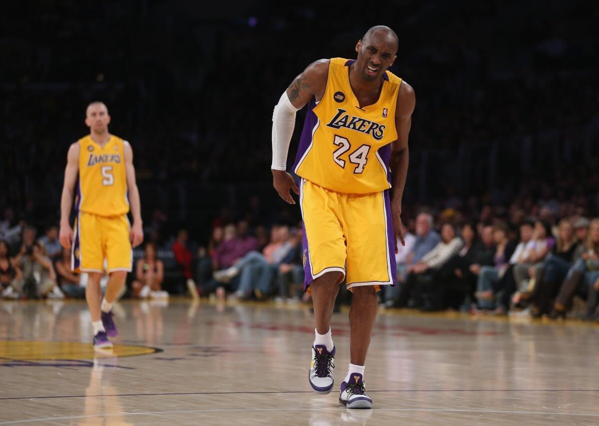 Kobe Bryant grimaces after injuring his leg in the third quarter of the Lakers' win over Golden State at Staples Center on Friday night.