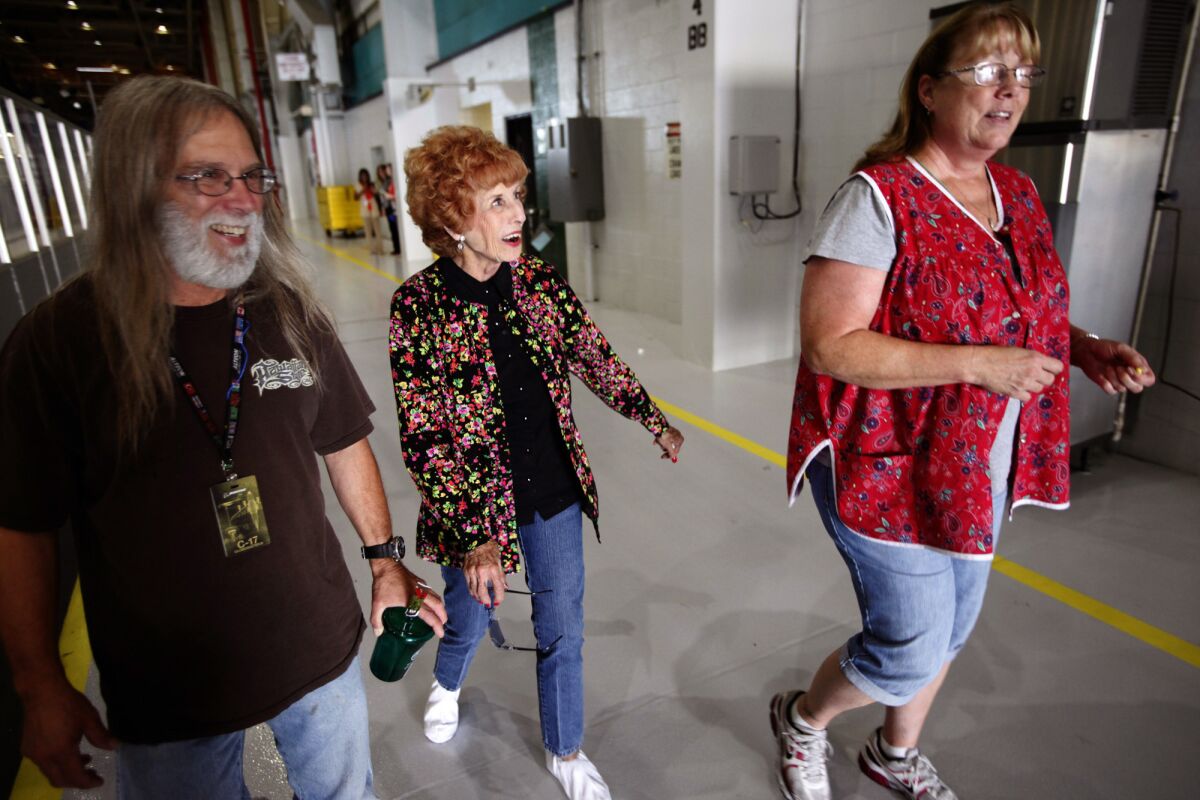 Elinor Otto, center, walks with co-workers Craig Ryba, left, and Kim Kearns at Boeing in Long Beach.