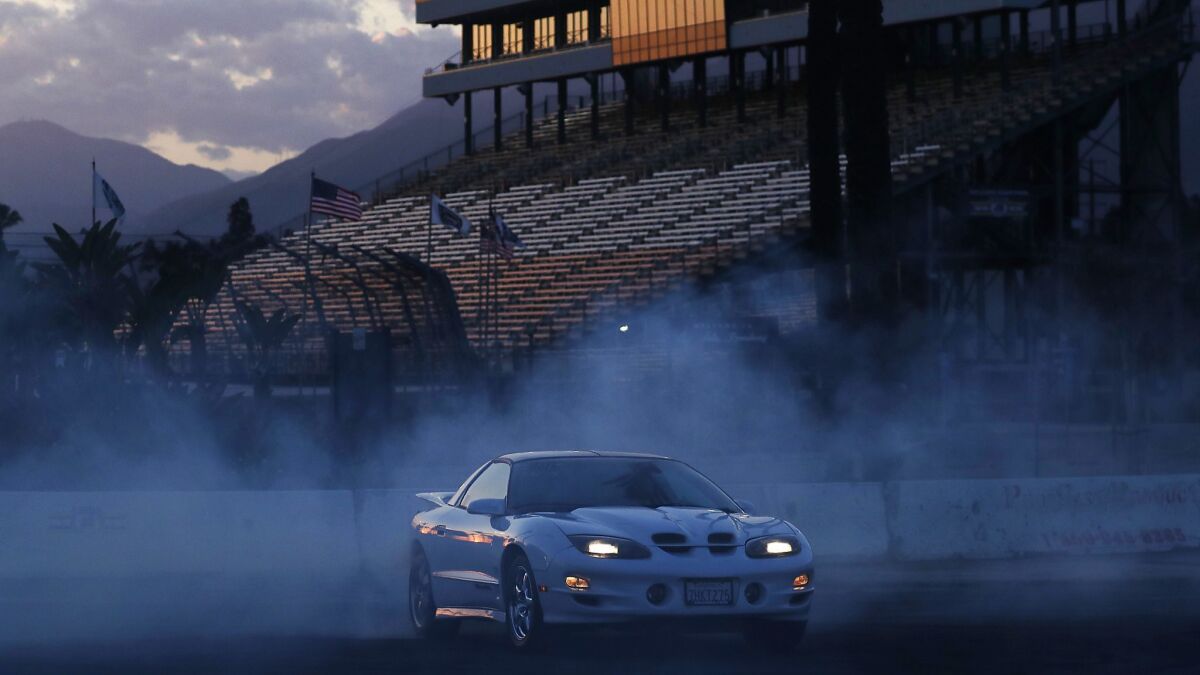 A driver burns rubber in the burnout pad of the Irwindale Speedway in Irwindale. The track hosts weekly racing and drifting events on Thursdays, which attract hundreds of car enthusiasts.