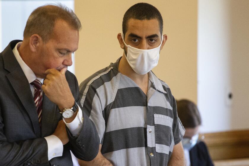 FILE - Defense attorney Nathaniel Barone, left, and Hadi Matar, 24, right, listen during an arraignment in the Chautauqua County Courthouse in Mayville, NY., Thursday, Aug. 18, 2022. Matar, who severely injured author Salman Rushdie in a frenzied knife attack in western New York faces a new charge that he supported a terrorist group. An indictment unsealed in U.S. District Court in Buffalo on Wednesday, July 24, 2024, charges Matar with providing material support to Hezbollah, a militant group based in Lebanon and backed by Iran. (AP Photo/Joshua Bessex, File)