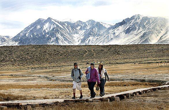 Alex Ethery, left, strolls with Cerro Coso Community College students Sharon Carroll and Katie Garman along a path leading to hot springs near Mammoth Lakes.