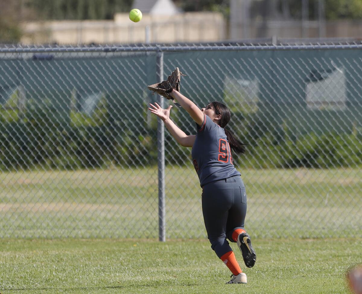 Los Amigos outfielder Anais Alarcon makes a running catch deep in left field for an out against Loara on Friday.