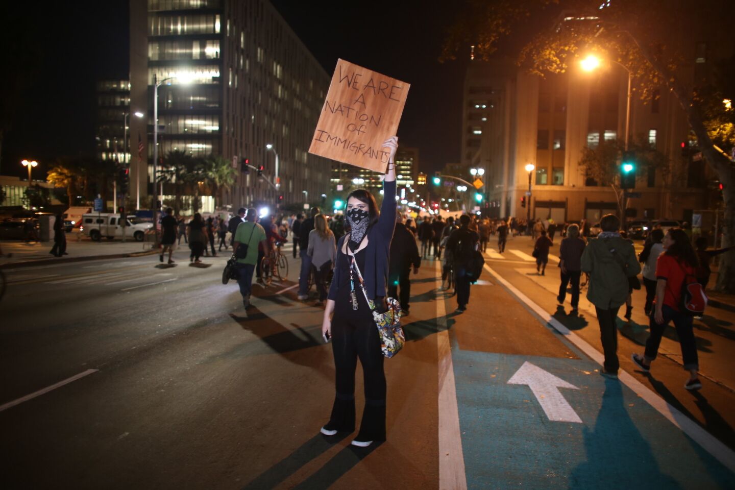 A protester stands in the middle of Spring Street in downtown Los Angeles during an anti-trump march Friday night.