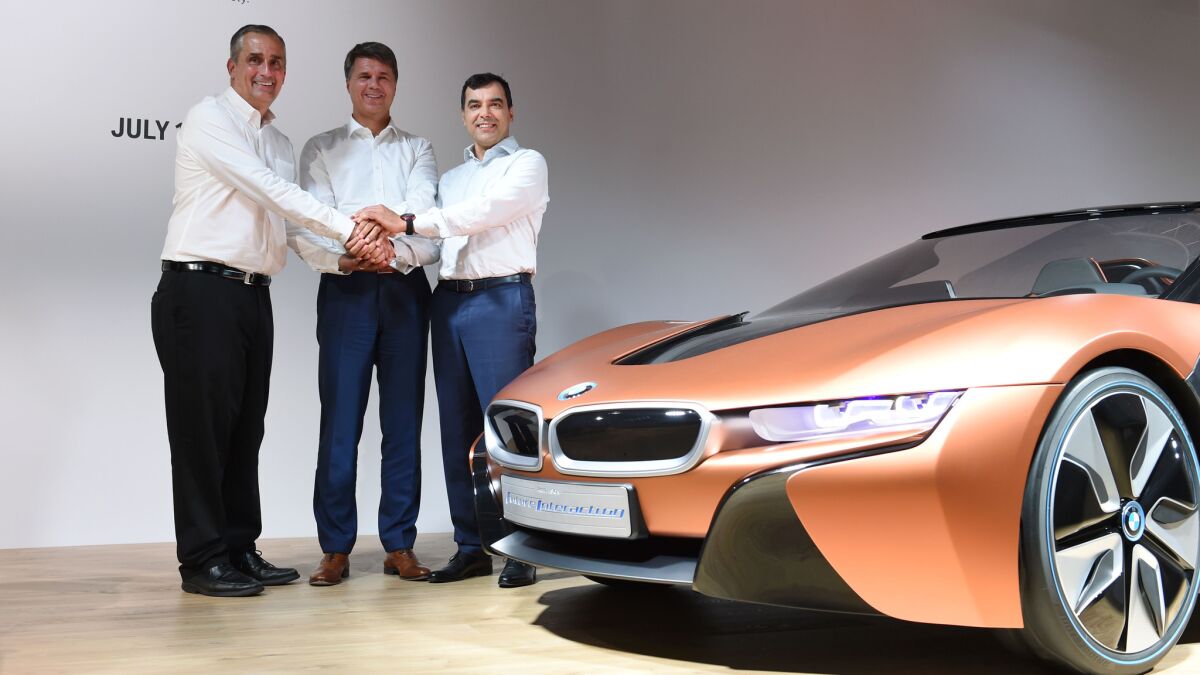 Intel CEO Brian Krzanich, left, BMW CEO Harald Krueger and Amnon Shashua, chairman of Mobileye NV, pose after a news conference in Munich on July 1, 2016. (Christof Stache / AFP/ Getty Images)