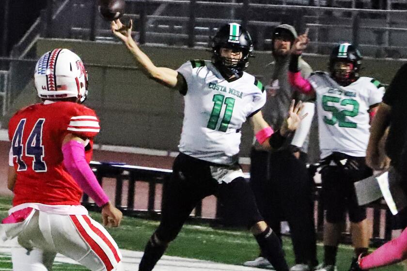 Costa Mesa's quarterback Andrew Waiss (11) passes against Bolsa Grande High School boys' football team.