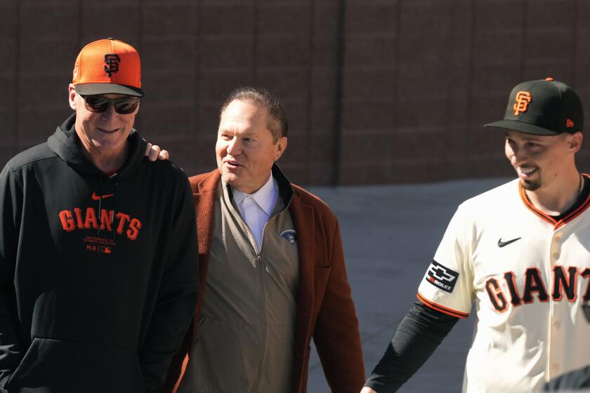 San Francisco Giants manager Bob Melvin, left, smiles as he talks with agent Scott Boras, center, prior to new Giants pitcher Blake Snell, right, being introduced during a baseball news conference Wednesday, March 20, 2024, in Scottsdale, Ariz. (AP Photo/Ross D. Franklin)