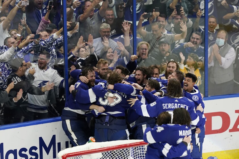 The Tampa Bay Lightning celebrate their series win over the Montreal Canadiens to clinch the Stanley Cup in Game 5 of the NHL hockey finals, Wednesday, July 7, 2021, in Tampa, Fla. (AP Photo/Gerry Broome)