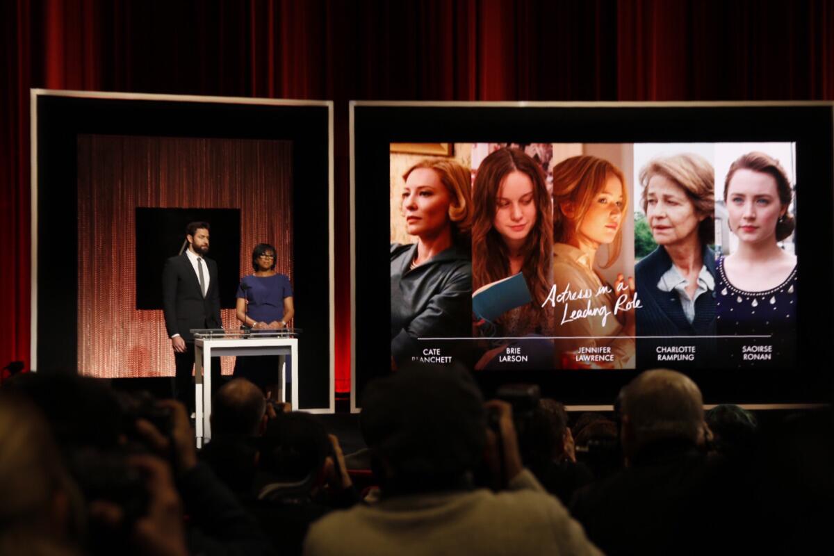 Actor John Krasinski, left, and Academy President Cheryl Boone Isaacs announce nominees for the lead actress category.