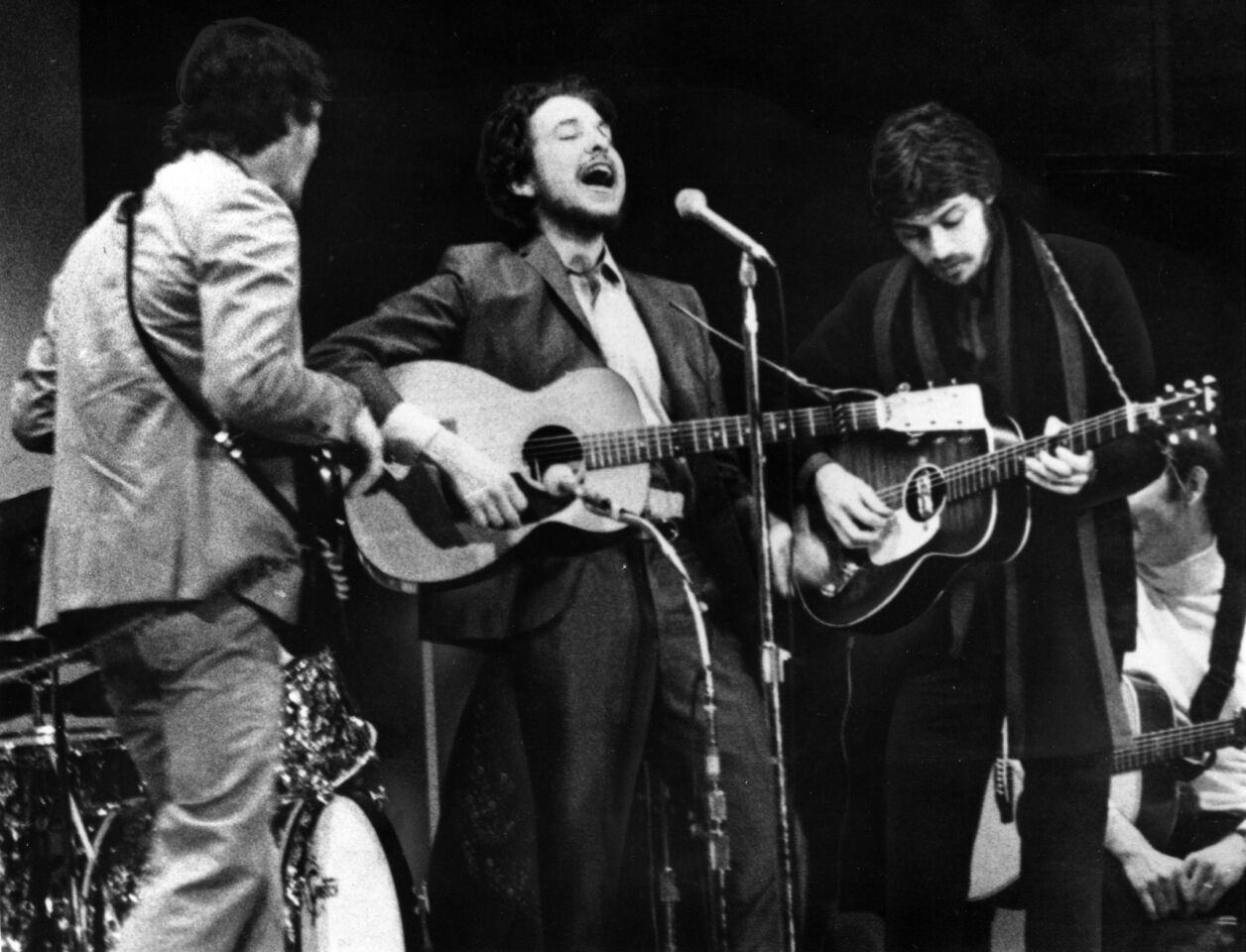After recovering from a near-fatal 1966 motorcycle crash, Dylan regrouped, playing with a backing band soon to be known as the Band. Eschewing touring, they instead recorded dozens of songs in widely bootlegged sessions later known as "The Basement Tapes." They are shown performing Jan. 20, 1968, in New York City's Carnegie Hall.