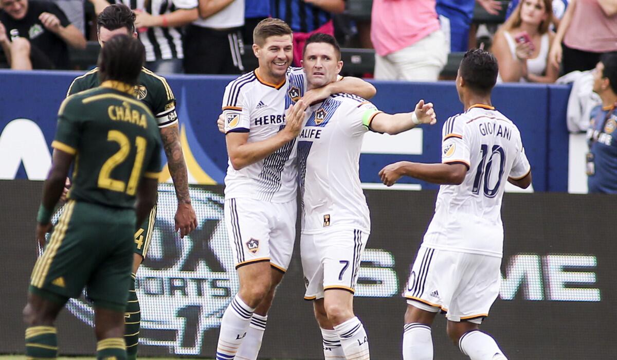 Los Angeles Galaxy forward Robbie Keane (7), celebrates his goal with teammates Steven Gerrard (8) and Giovani dos Santos (10) during a game against the Portland Timbers on Oct. 18.