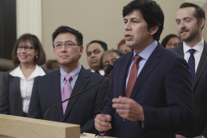 State Senate President Pro Tem Kevin de Leon, D-Sacramento, accompanied by state Treasurer John Chiang, discusses a proposal to automatically enroll-private sector workers in a state-run retirement account during a news conference in Sacramento on March 28.