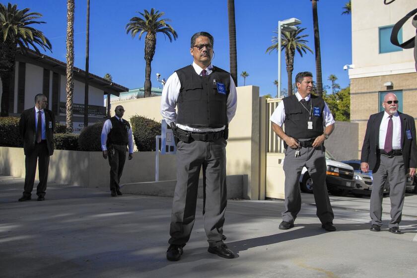 Riverside County court security officers stand guard after federal officials transported Enrique Marquez to a hearing, where he was charged in connection with two unfulfilled terrorism plots with the San Bernardino gunman.