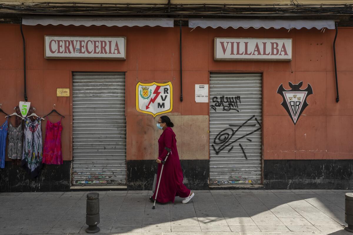 A masked woman in Vallecas neighborhood of Madrid
