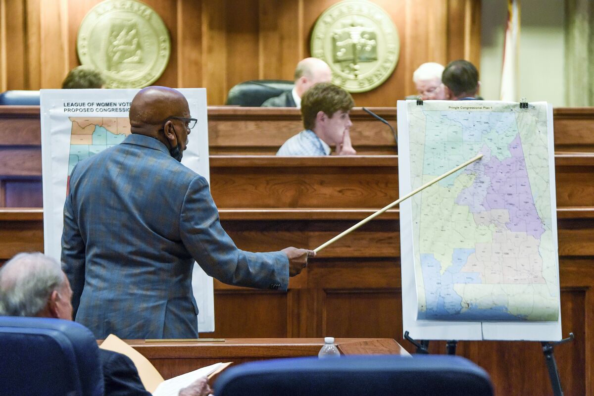 Sen. Rodger Smitherman compares maps in a session on redistricting in Alabama last week.