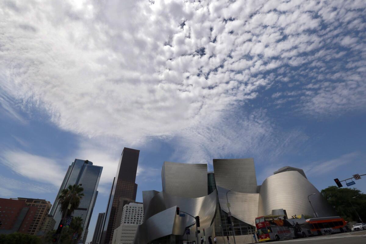 Clouds accompany hot, muggy weather over downtown Los Angeles and the Walt Disney Concert Hall, Thursday, July 30, 2015. July is wrapping up in California with more of the unusual weather that has marked the normally very dry month. Flash-flood watches are posted across the interior mountains and deserts of southern and eastern California as monsoonal moisture brings thunderstorms.(AP Photo/Nick Ut)