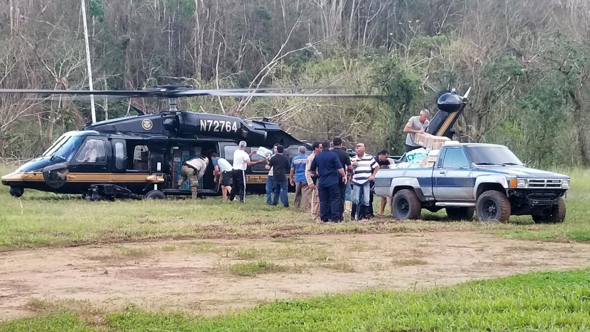 A helicopter bringing aid lands in the mountain community of Castaner, Puerto Rico.