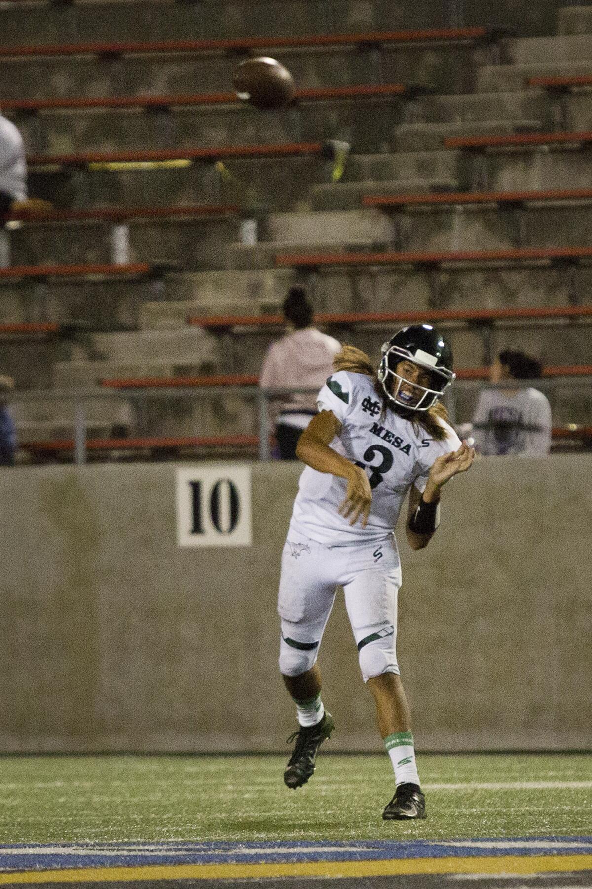 Costa Mesa's Nick Burton throws a short pass in an Orange Coast League opener against Santa Ana on Thursday at Santa Ana Stadium.