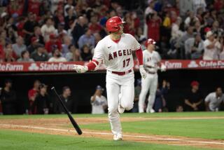 Angels designated hitter Shohei Ohtani (17) flips his bat after flying out against the Dodgers on June 20, 2023 in Anaheim.