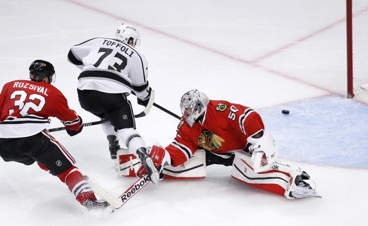 Kings forward Tyler Toffoli watches his shot head toward the post after beating Blackhawks defenseman Michal Rozsival and goalie Corey Crawford in the third period.