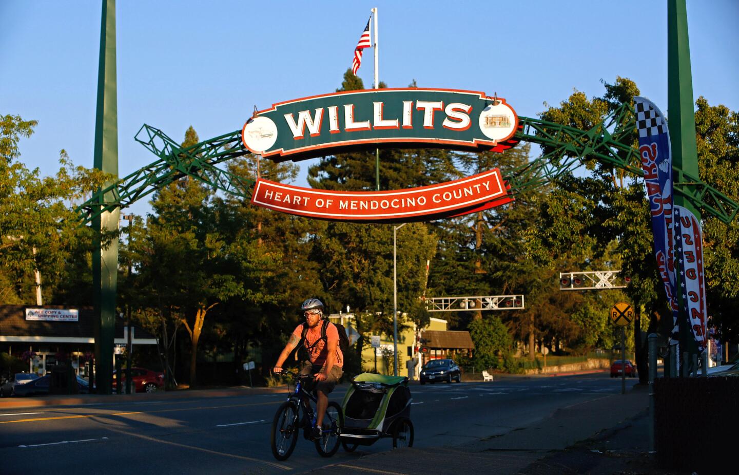 A bicycle rider makes his way through Willits.