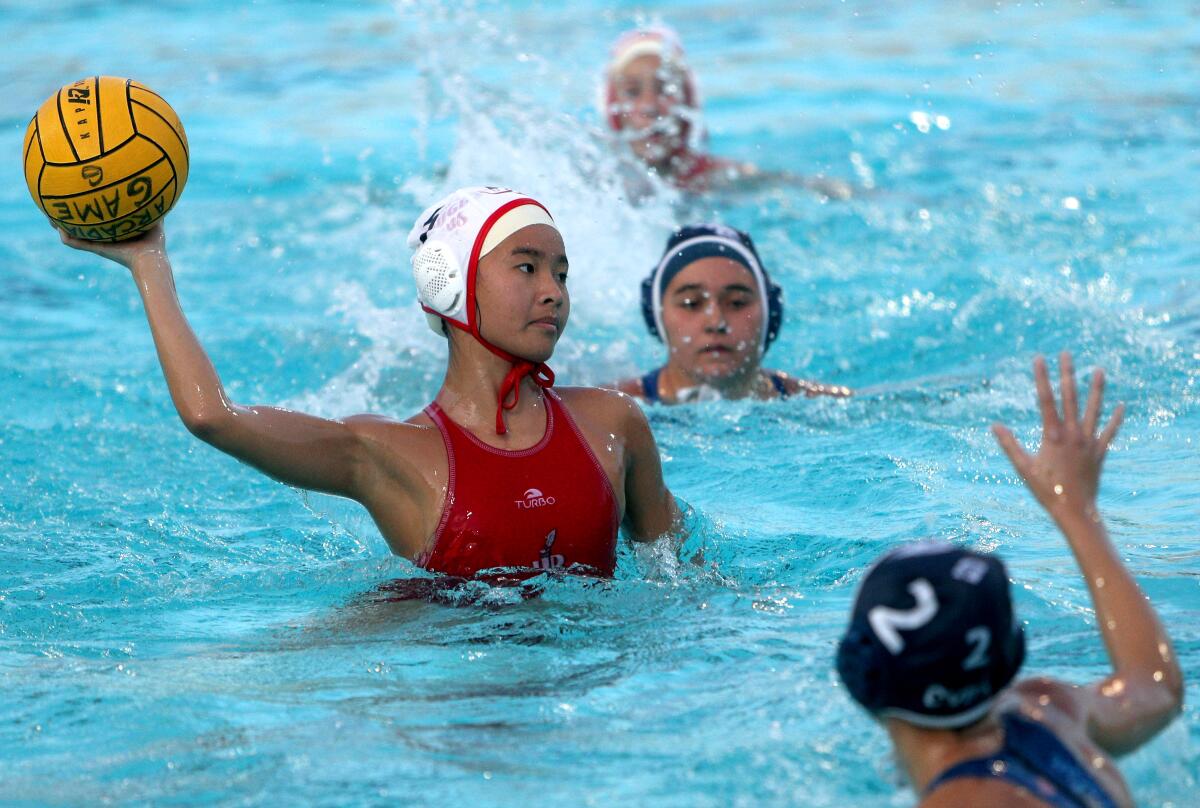 Burroughs High water polo player Angelina Lee takes a shot on goal in the Pacific League Tournament semifinal vs. Crescenta Valley High, at Arcadia High in Arcadia on Tuesday, Feb. 4, 2020. Burroughs won 10-3.