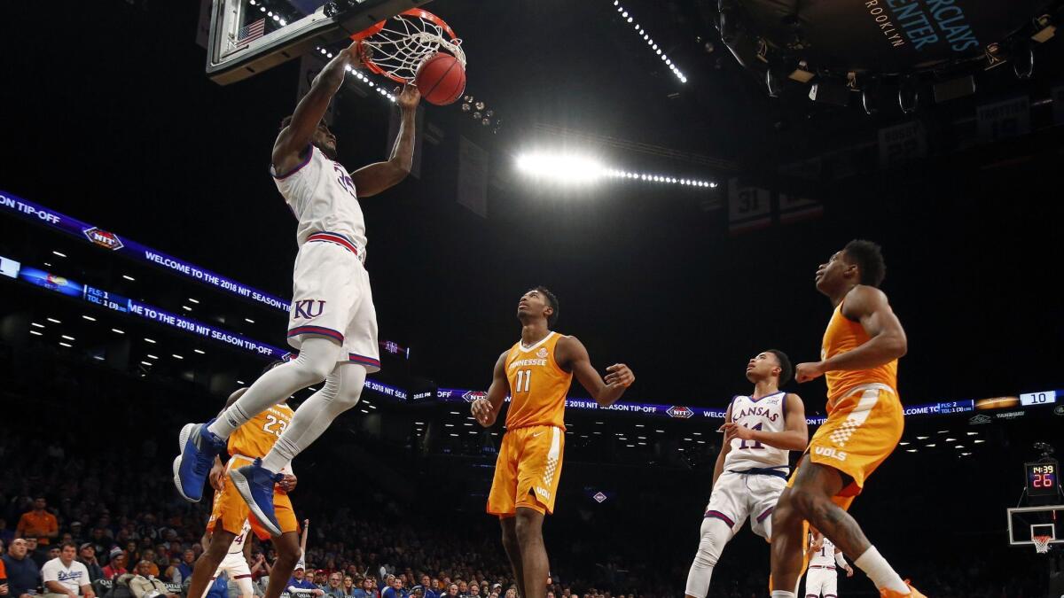 Kansas center Udoka Azubuike (35) dunks in front of Tennessee forward Kyle Alexander (11) during the first half.
